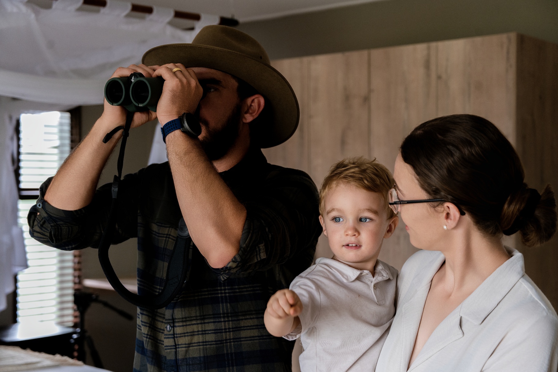 Family watching wildlife with binoculars
